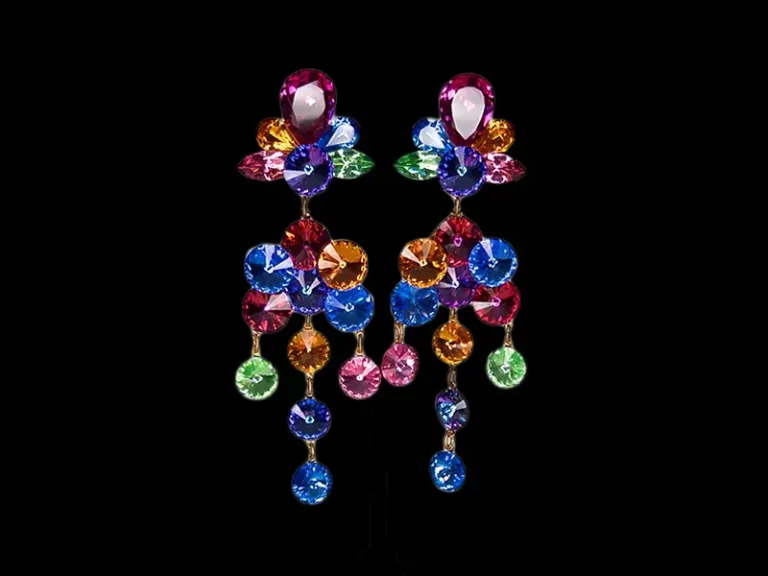 Multicolored dangle earrings with bright crystal stones on display stand, linking to the VOLU Etsy product page.